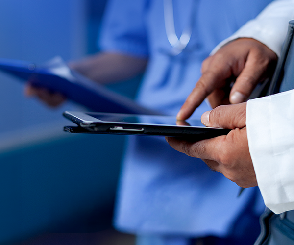 Clinicians reviewing data on a tablet